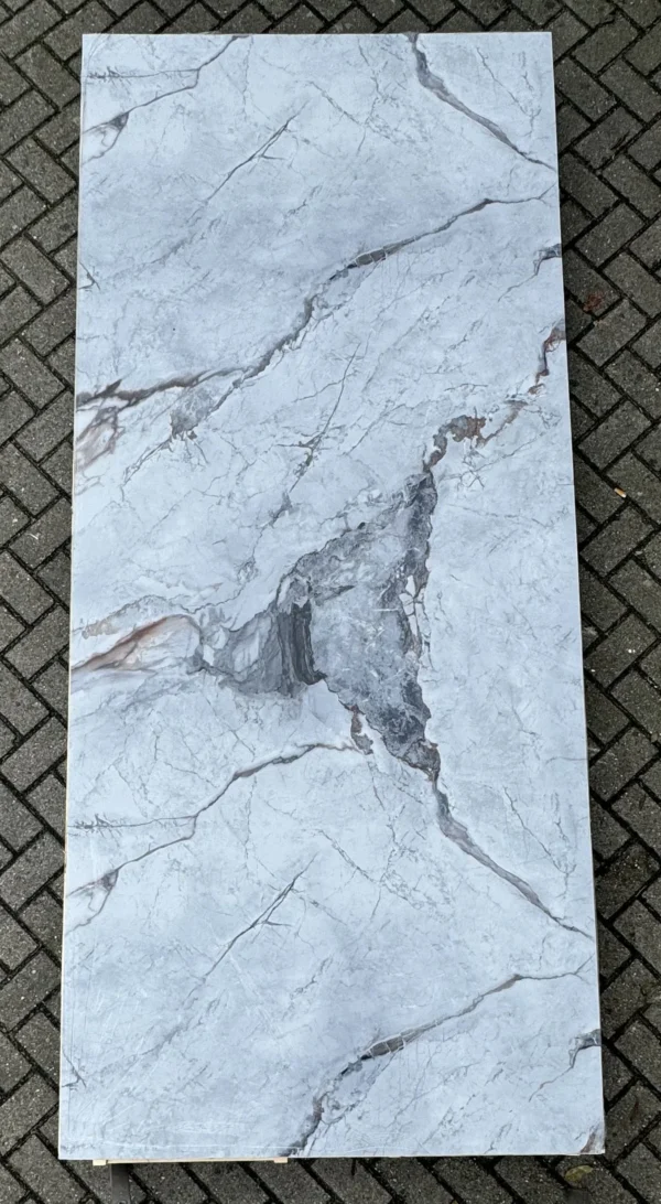 a white rectangular object on a brick surface