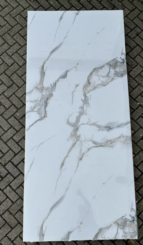 a white rectangular marble slab on a brick surface